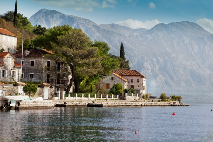 Houses by the sea in Perast, Montenegro with mountains
