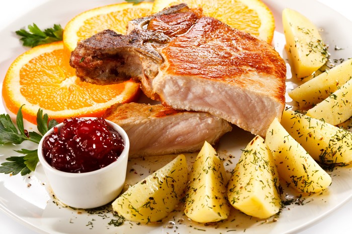 Pork Chop with Potatoes, Oranges, and Cranberry Sauce
