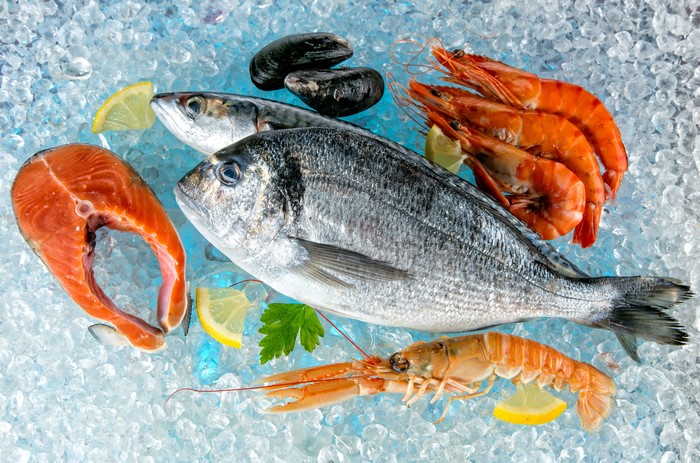 Seafood assortment on ice with lemons