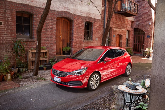 Red 2016 Holden Astra RSV parked in alley
