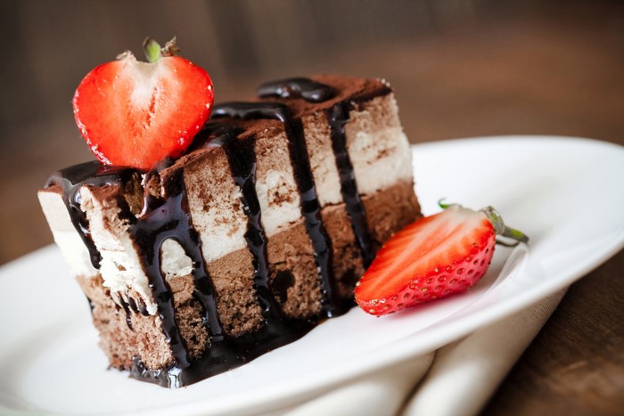Chocolate cake with strawberries and chocolate syrup