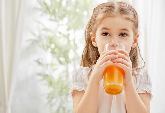 Little girl drinking juice from a glass