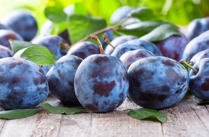 Plums closeup on wooden surface