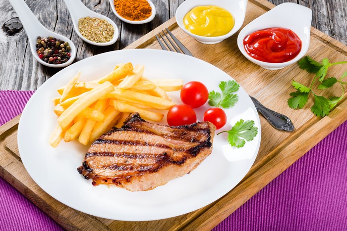 Grilled Pork Chop with French Fries and Tomatoes