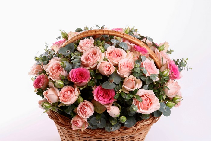Pink and red roses in a wicker basket
