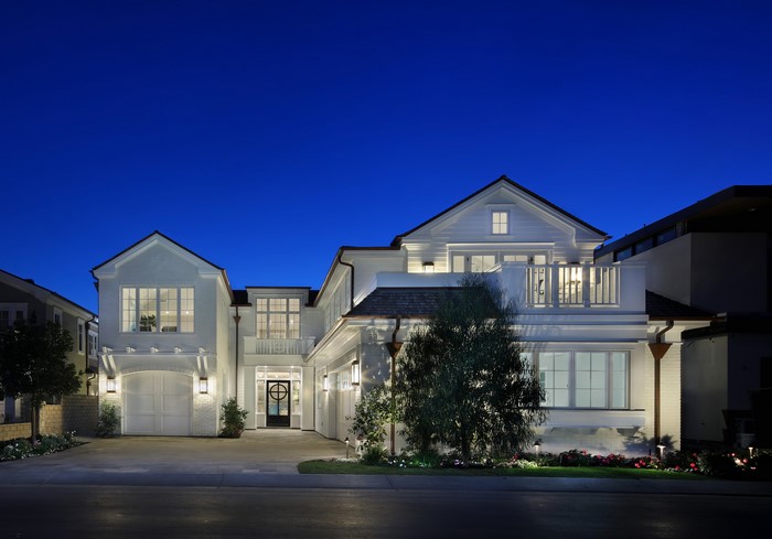 Modern White House with Garage and Balcony at Night