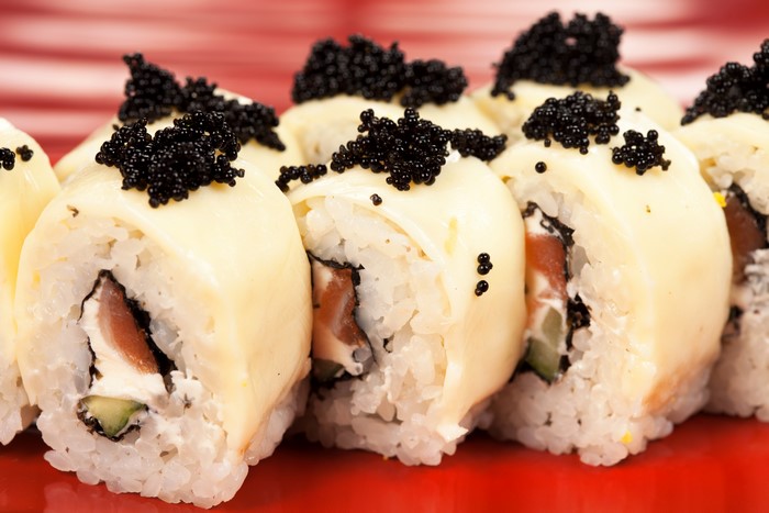 Sushi rolls with caviar and cheese