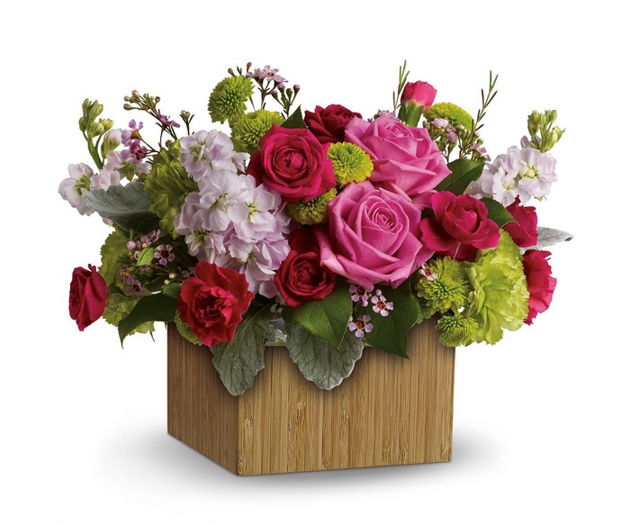 Floral arrangement in a wooden cube vase