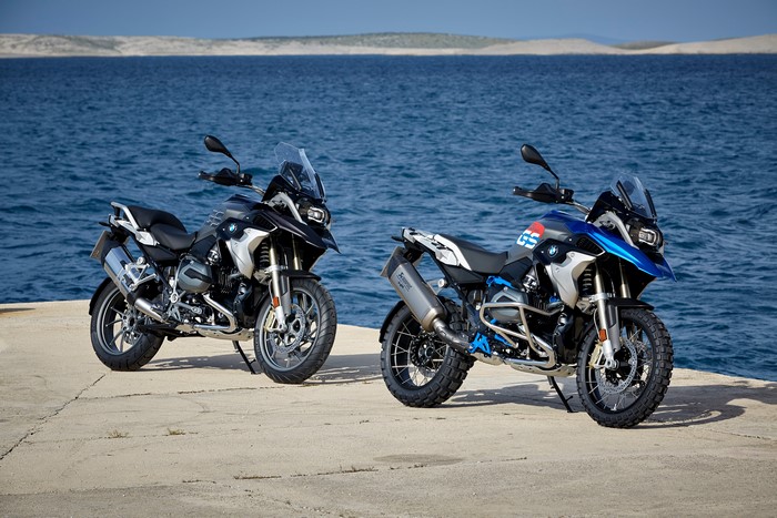 Two BMW R 1200 GS motorcycles on a coast