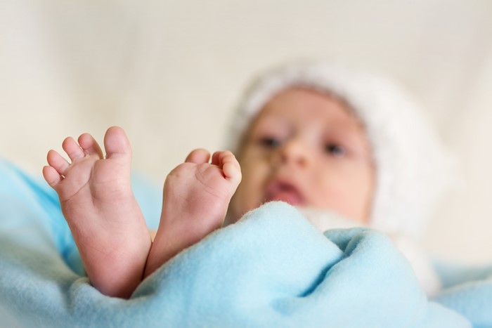 Baby's Feet Wrapped in Blue Blanket