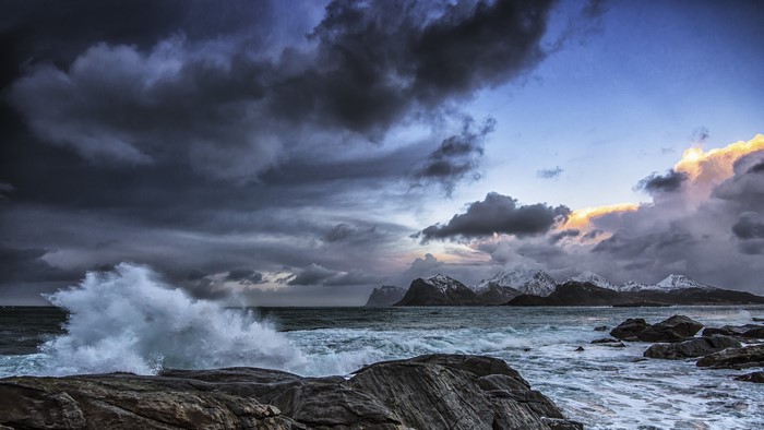 Stormy Sky Over Rocky Coastline and Mountains