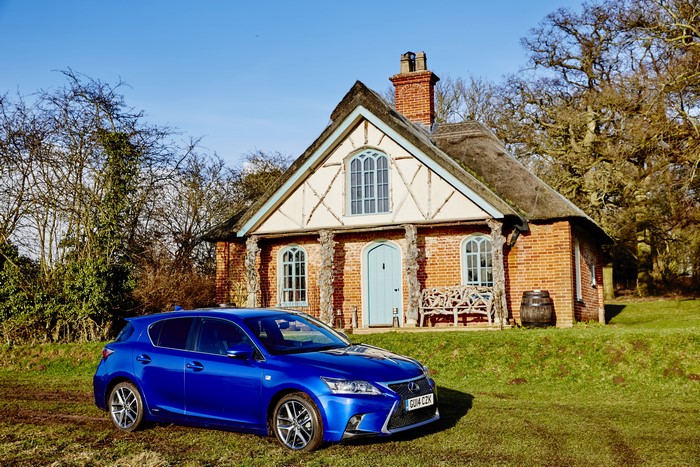 Blue 2014-16 Lexus CT 200h F-Sport by a thatched cottage