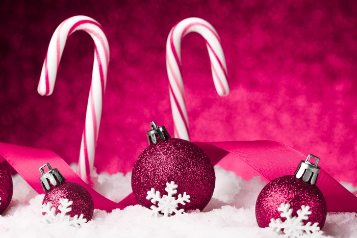 Christmas candy canes and ornaments in snow
