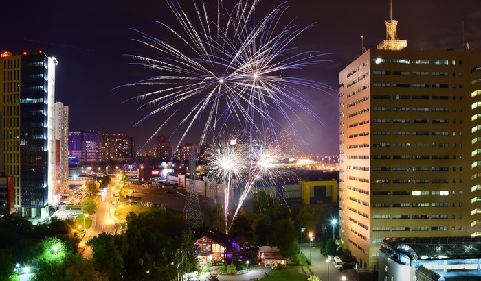 Fireworks over city buildings at night