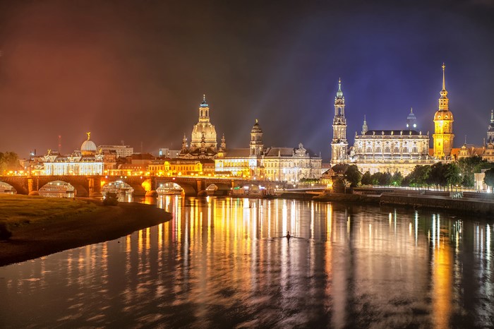 Dresden skyline with river and bridge at night