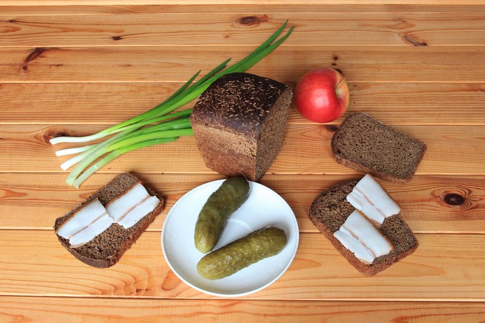 Bread, Cucumbers, Salo, Apple, and Green Onions on Wood