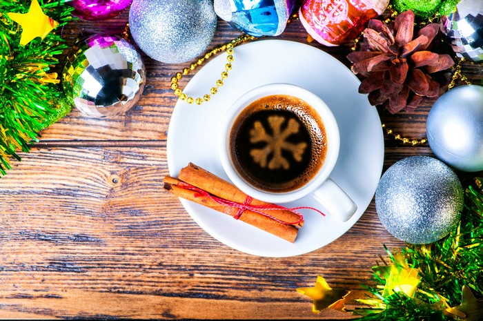 Christmas coffee with cinnamon and ornaments