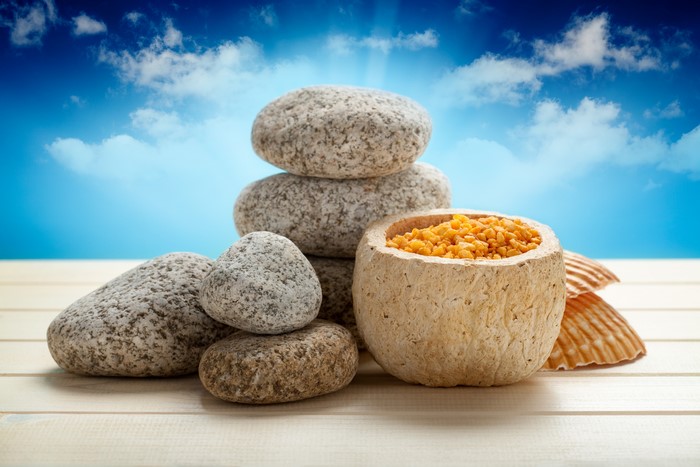 Spa stones and salt with shells and sky