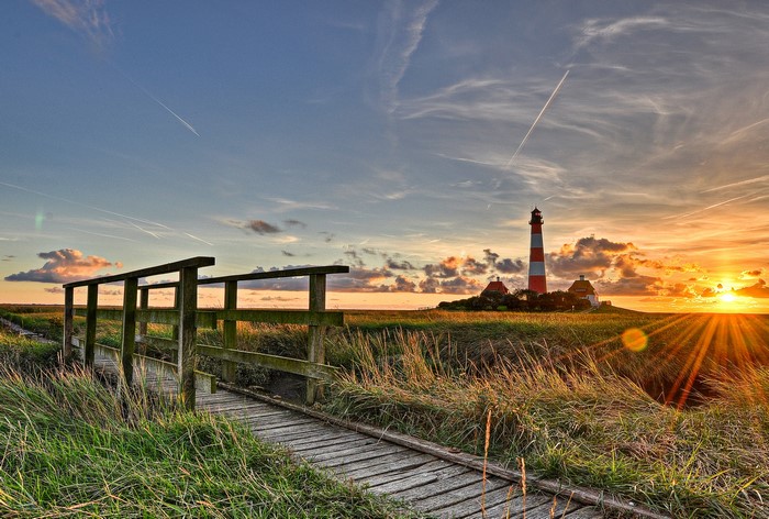 Westerhever Lighthouse at Sunset with Wooden Bridge