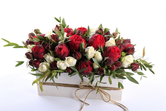 Red and white roses in a wooden box