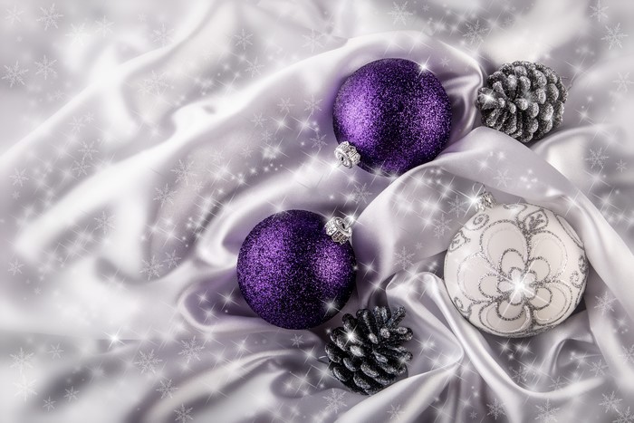 Christmas ornaments and pine cones on satin