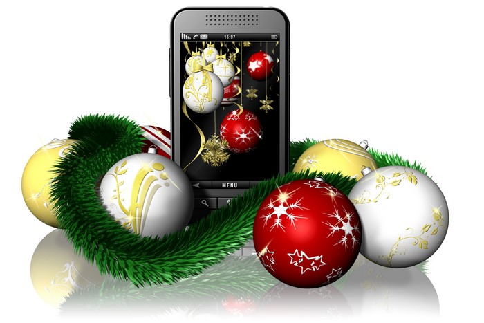 Smartphone with Christmas ornaments and tinsel