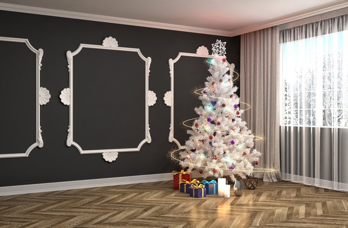 Christmas tree with gifts and candles in a room