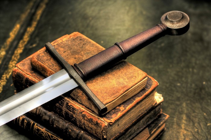 Sword resting on old books