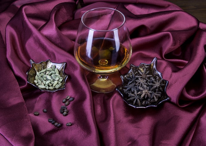Glass of Brandy with Spices and Coffee Beans