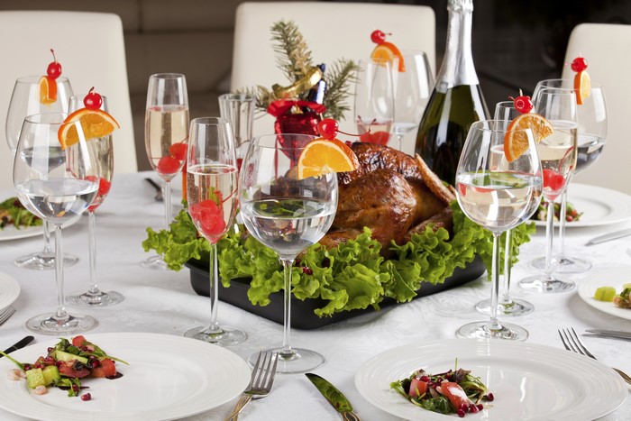 Thanksgiving Dinner Table Setting with Roast Turkey and Champagne