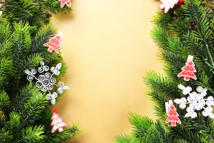 Christmas tree branches with ornaments and snowflakes