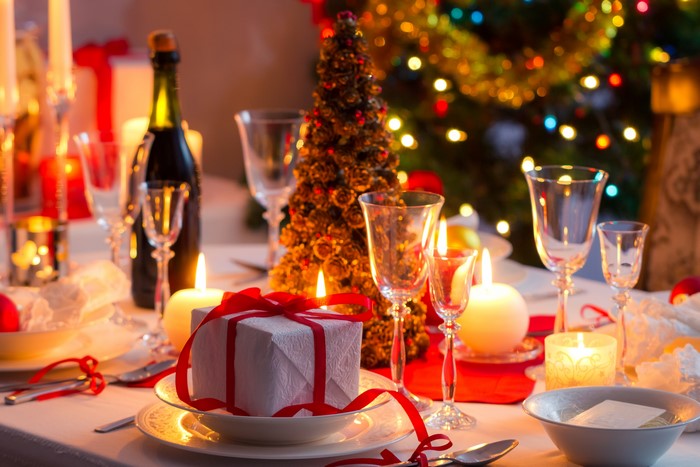 Christmas table setting with gifts and candles