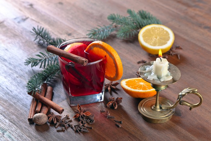 Mulled wine with orange, cinnamon, and candle