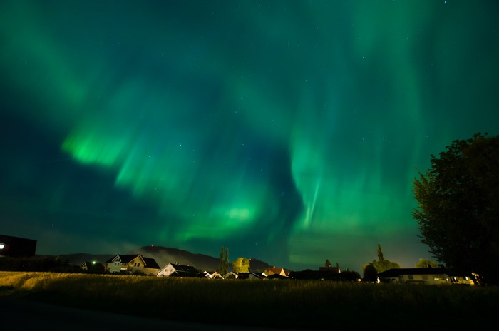Aurora Borealis over a village at night
