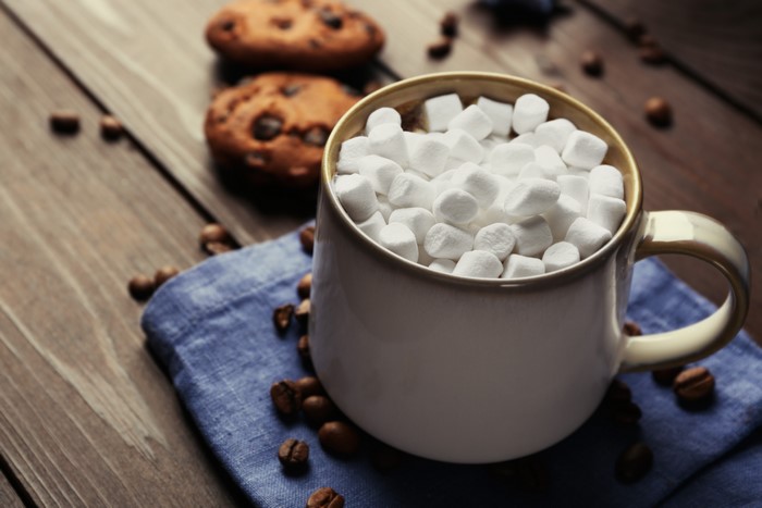 Mug of hot chocolate with marshmallows and cookies
