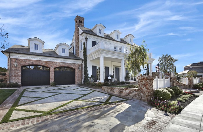Luxury Mansion with Brick Garage and White Balcony