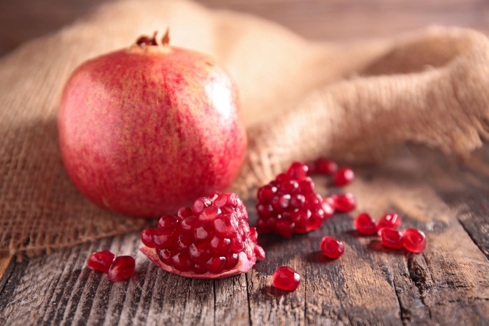 Pomegranate on Burlap and Wood