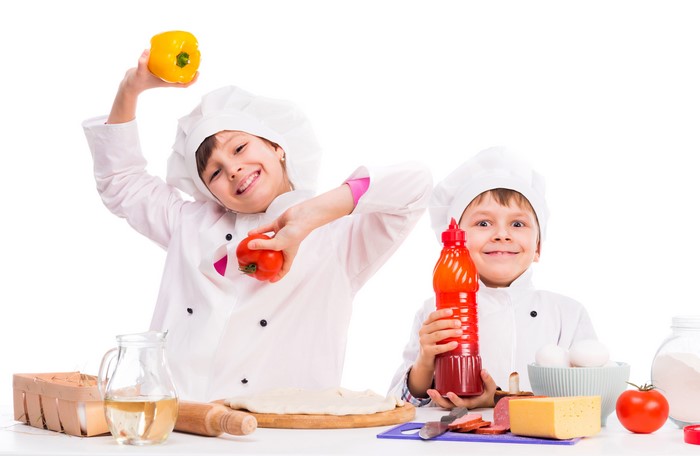 Two young chefs with cooking ingredients