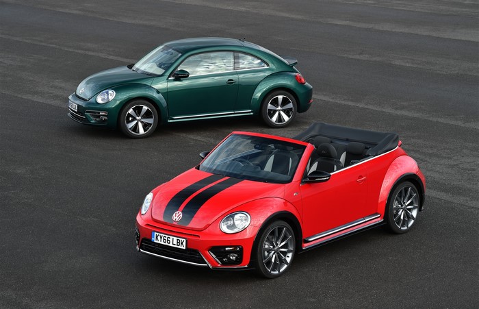 Two Volkswagen Beetles, one red convertible and one green coupe