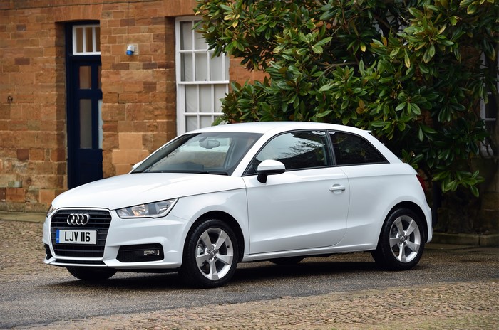 White Audi A1 TDI parked outside brick building