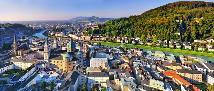 Salzburg cityscape with river and mountains, Austria