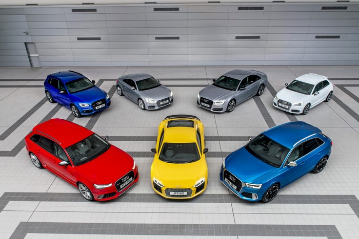 Collection of Audi cars parked in a modern building
