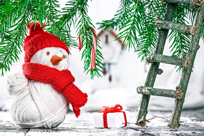 Christmas snowman with candy canes and gift