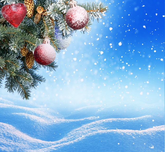 Christmas tree branches with ornaments and snow
