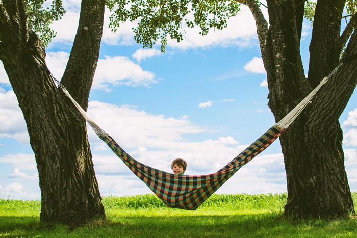 Boy in a hammock between two trees