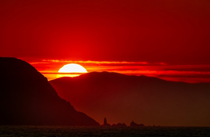 Sunset over mountains and sea