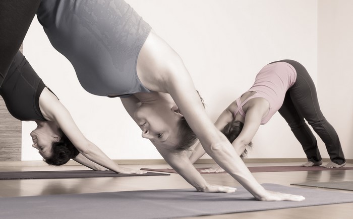 Women practicing Downward-Facing Dog yoga pose