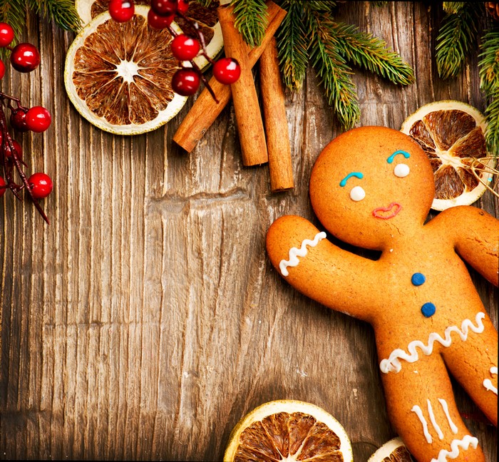 Christmas gingerbread man with cinnamon and dried oranges