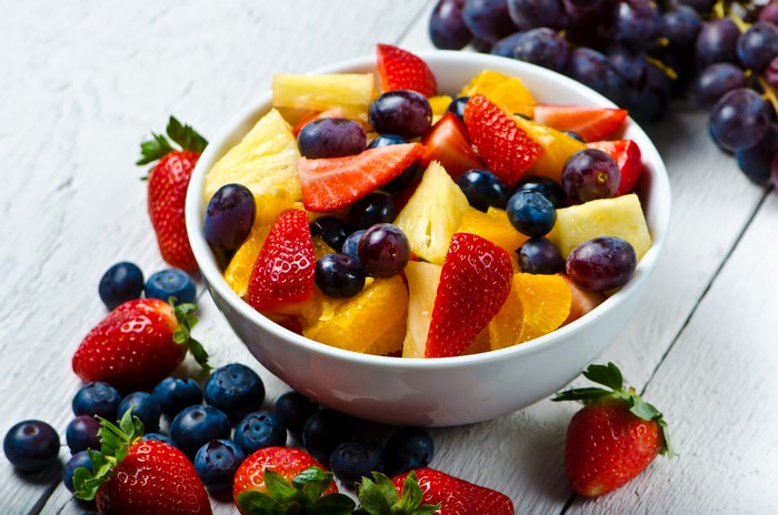 Fruit salad with strawberries, blueberries, grapes, and pineapple
