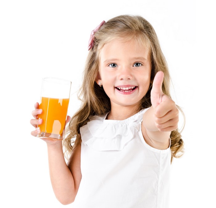 Girl holding a glass of juice and giving a thumbs up